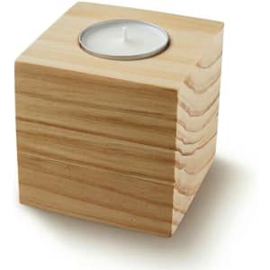 A wooden cube candle holder with a circular space for a tea light candle on top. Natural wood finish.