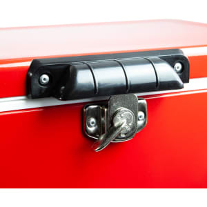 A red metal ice cooler box with a black handle and lock mechanism on the top.
