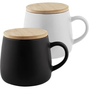 A coffee mug set in black and white with wooden lid tops and curved handles. Features a simple, modern design.