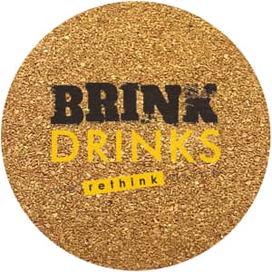 A round cork coaster with a textured golden surface and a logo in black and yellow.