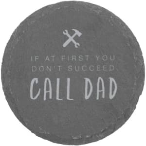 A round slate coaster featuring grey tones and an inscription about calling Dad for help.