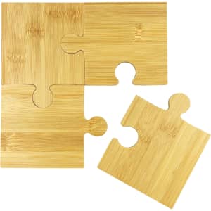 A bamboo coaster set featuring four interlocking puzzle pieces in a natural finish.