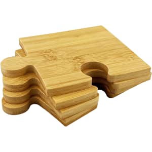 A set of bamboo coasters featuring a puzzle piece design, showcasing light brown wood tones.
