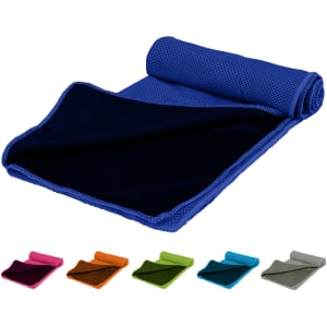 A blue cooling towel with a textured surface, rolled up and laid out next to several other coloured towels.