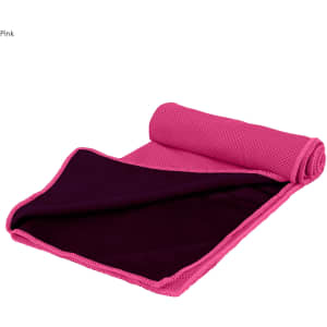 A pink cooling towel with a textured surface, neatly rolled up and partially unfurled to show its interior fabric.