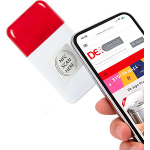 A correction tape dispenser in white and red, alongside a smartphone displaying a webpage, featuring a logo.