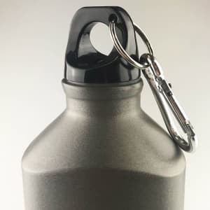 A drink bottle in matte grey with a black top and attached carabiner for convenient carrying.