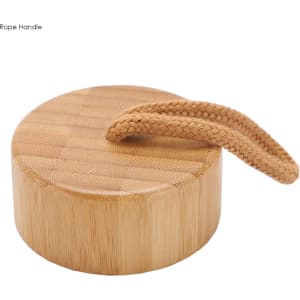 A bamboo drink bottle lid features a textured surface with a braided rope handle. Natural bamboo colour.