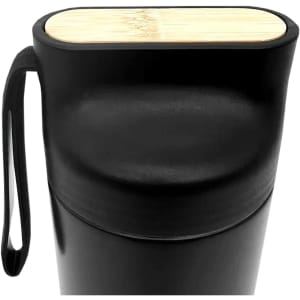 A drink bottle in matte black with a bamboo top and a side loop for easy carrying.