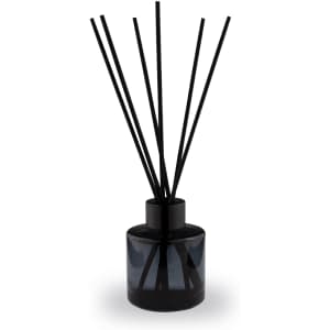 A round, 50ml classic reed diffuser in a black glass bottle with black reeds. Features a simple design.