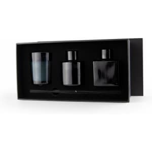 Aroma diffuser and candle gift box featuring a blue candle, two black diffusers, and a stir stick in a sleek black box.