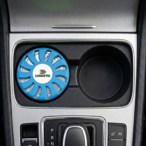 A blue air freshener with a circular design, placed in a car's cup holder. It has a logo on it.