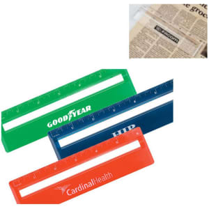 Three magnifying rulers in green, blue, and orange are arranged together, with a newspaper underneath. Each ruler features a logo.