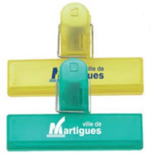 Three office clips in yellow and green, featuring branding on the surface.