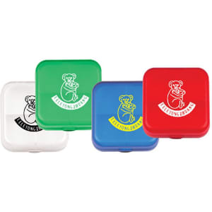 A set of four pill boxes in white, green, red, and blue, each featuring a logo of a koala.