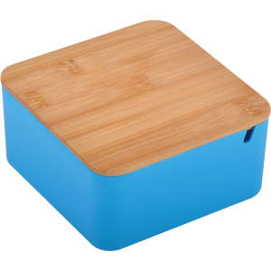 A square toiletry bag in bright blue with a natural bamboo lid and a small opening. It features a logo.
