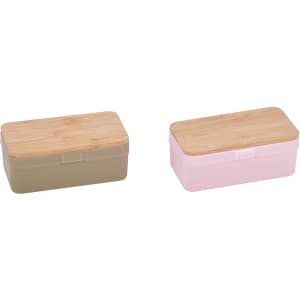 Two storage containers in olive green and light pink, each with a wooden lid.