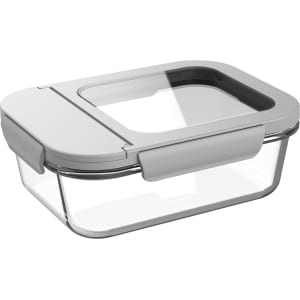 A glass lunch box with a transparent body and a grey lid, featuring a secure locking mechanism.