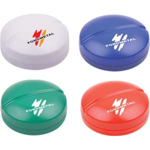 A set of four pill boxes in white, blue, green, and red, each with a circular design and branding.