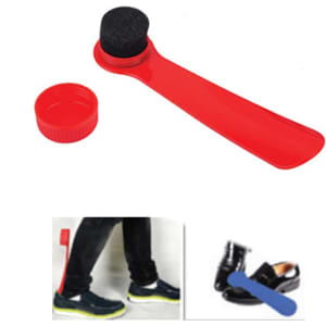 A red shoe horn with a brush cap. The brush is black and the horn is smooth. Includes a container for storage.