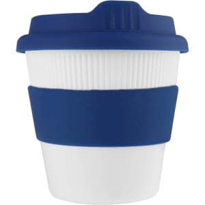 A reusable coffee cup with a white body and a navy blue silicone sleeve and lid, featuring a logo.