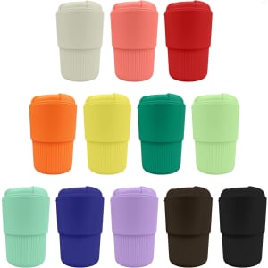 A collection of reusable coffee cups in various colours, featuring a textured grip and a lid, each with a logo.