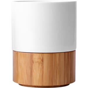A ceramic mug with a white top and a natural bamboo base, featuring a simple, modern design.