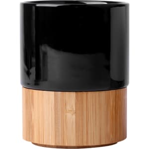 A black ceramic mug with a bamboo base, perfect for tea or coffee, featuring a smooth finish and simple design.