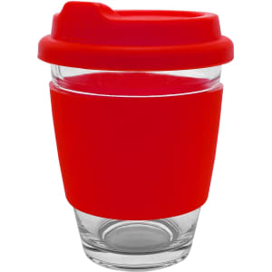 A glass coffee cup with a red silicone sleeve and lid. It features a clear glass design and a logo on the sleeve.