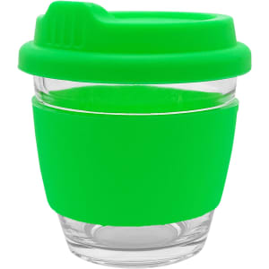 A reusable coffee cup in vibrant green with a silicone sleeve and lid, featuring a glass body and branding.