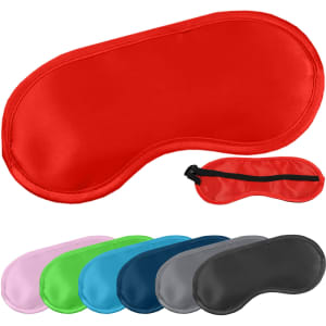 A red satin sleep eye mask surrounded by various coloured masks in pink, green, blue, and grey. The image includes a logo.