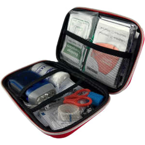 A red first aid case contains various medical supplies, including adhesive bandages, scissors, and antiseptic wipes, in mesh pouches.