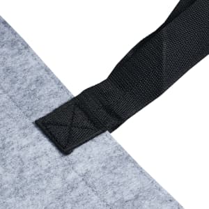 A grey felt tote bag with a black strap detail, featuring a simple attachment at the top.