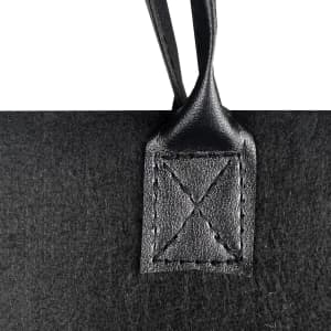 A black felt tote bag with a leather handle attachment, featuring decorative stitching. The bag has a simple, sleek design.