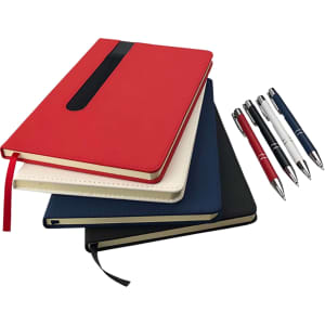 A stack of notebooks in red, white, navy, and black, accompanied by three pens in blue, black, and red.