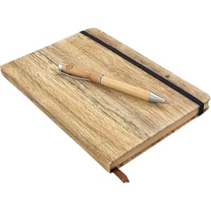 A wood-look notebook with a pen resting on top, featuring a natural finish and an elastic band.