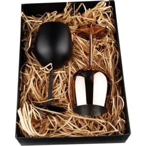 A black stainless steel wine glass and a copper stainless steel wine glass in a gift box with straw filling.