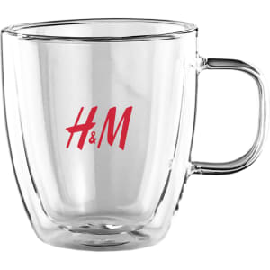 A drink cup made of transparent glass with a red logo, featuring a double wall design and comfortable handle.