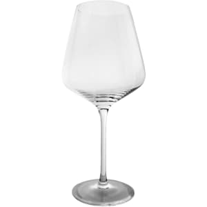 A wine glass in clear glass with a tall, elegant silhouette and a wide bowl, featuring a smooth, round base.