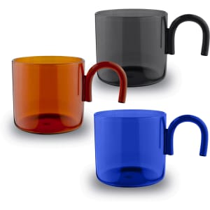 A set of three glass cups in orange, blue, and black, featuring a distinctive curved handle.