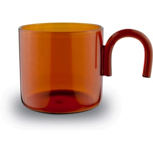 A transparent amber glass cup with a unique handle design, suitable for tea and coffee.