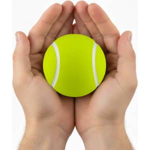 A bright yellow tennis ball is held gently between two hands. The ball features white stripes.