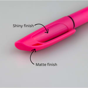 A pink highlighter with a shiny and matte finish, featuring a clip for easy attachment.