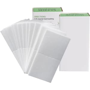 A pack of white travel paper soap sheets displayed beside their packaging. The product has a simple design with a logo.