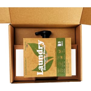 A brown box containing laundry detergent sheets and a black spout, with eco-friendly branding visible.