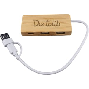 A bamboo USB hub with three ports and a white connecting cable, featuring a logo on the surface.