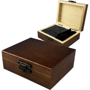 A wooden box with a clasp, containing black stone whiskey ice cubes inside a compartment.