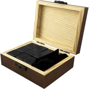 A wooden box containing nine black stone whiskey ice cubes and a velvet pouch, designed for chilling drinks.