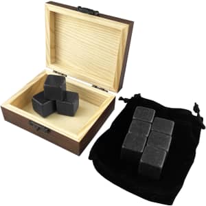 A wooden box containing grey stone whiskey ice cubes, with a black velvet pouch beside it holding additional cubes.