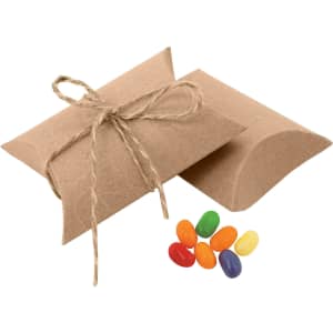A brown pillow-shaped package tied with twine beside colourful jelly beans in orange, yellow, green, and purple.